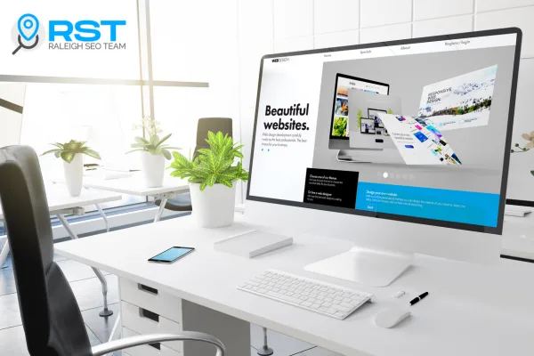 Modern office workspace with a computer displaying "Beautiful websites" on the Raleigh SEO Team's website, featuring a clean desk setup with plants and mobile device, emphasizing professional web design for small businesses.