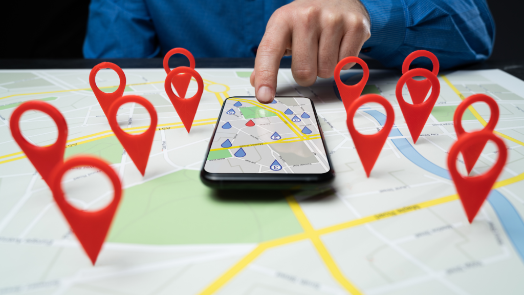 Person interacting with smartphone displaying a map and location pins, illustrating local SEO strategies for enhancing visibility in Raleigh.